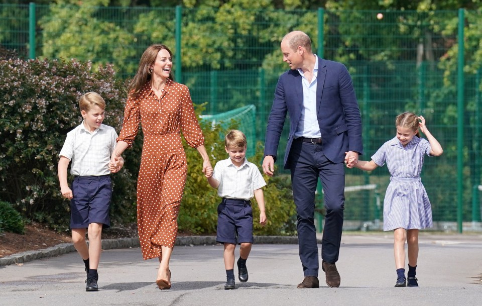 a family walking down a street holding hands