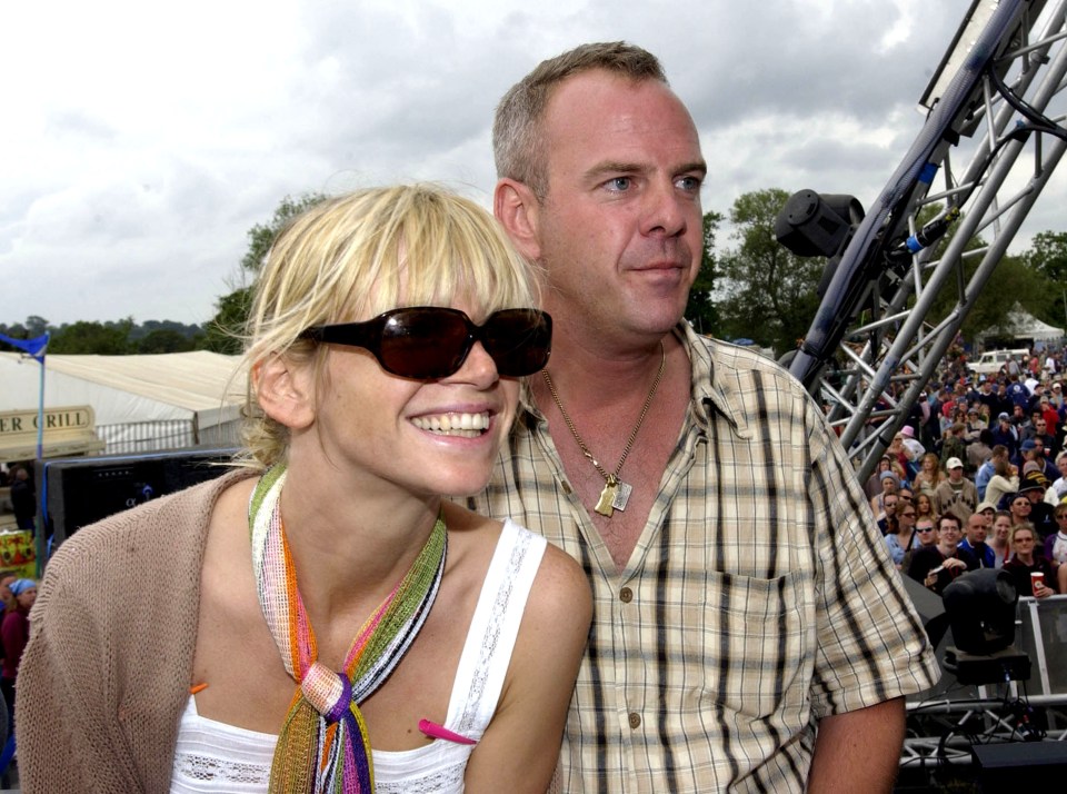 a woman wearing sunglasses stands next to a man in a plaid shirt