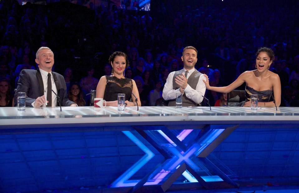 four people sitting at a table with a blue x on it