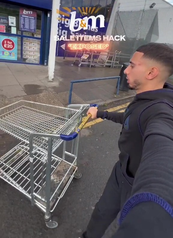 a man pushing a shopping cart in front of a bm store