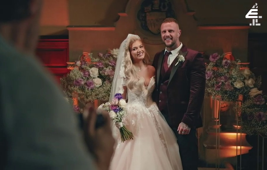 a man is taking a picture of a bride and groom