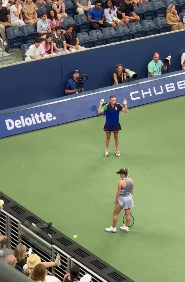 a tennis match is being played in front of a deloitte banner