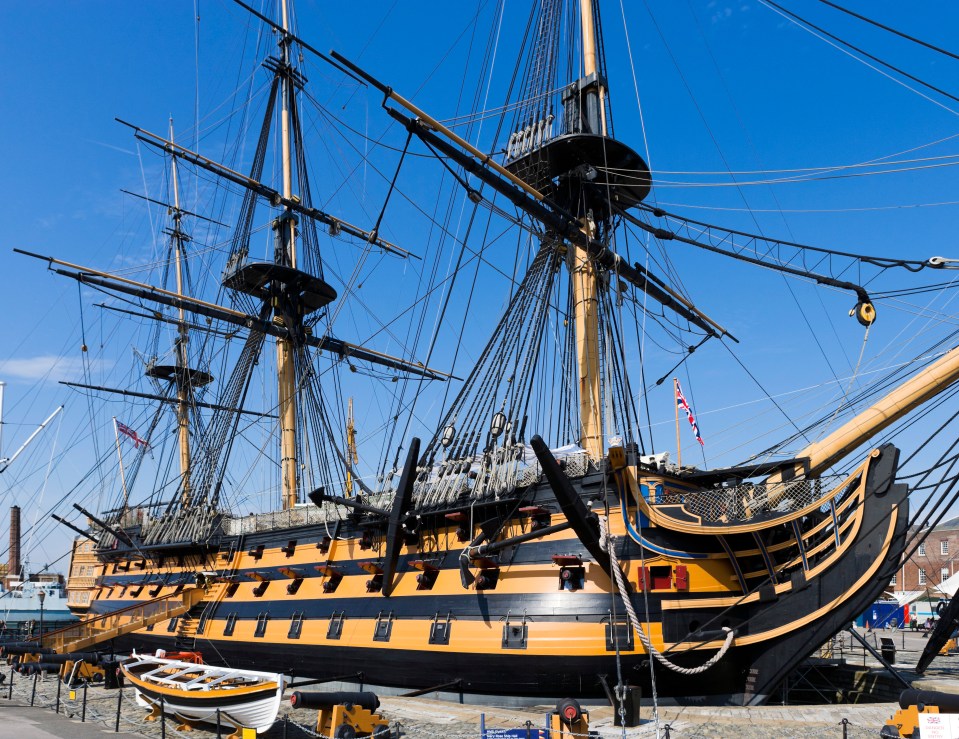 a large ship with a british flag on the mast