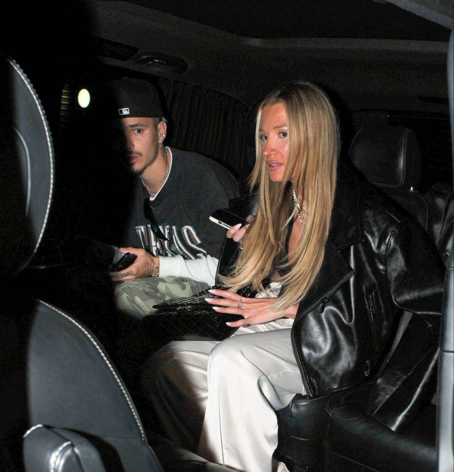 a man wearing a texas shirt sits next to a woman in a car