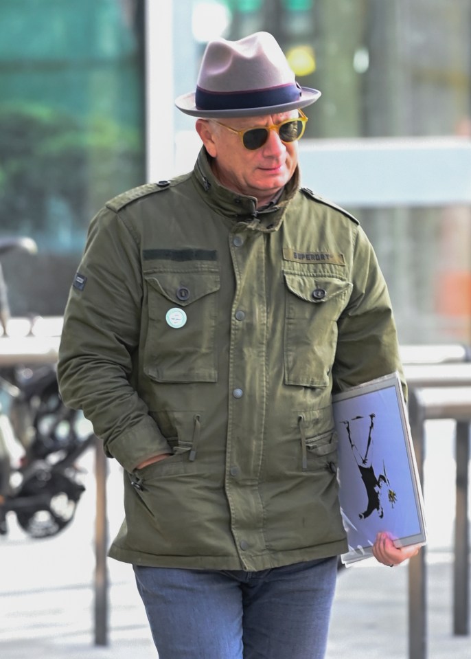 The soap star clutched a piece of artwork under his arm as he walked along Blue - a street in MediaCity