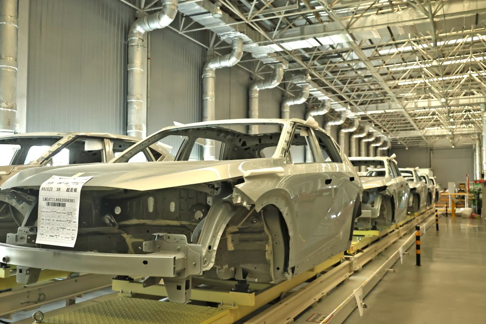 Car bodies are seen on the the intelligent assembly line at a workshop in Xinjiang, China