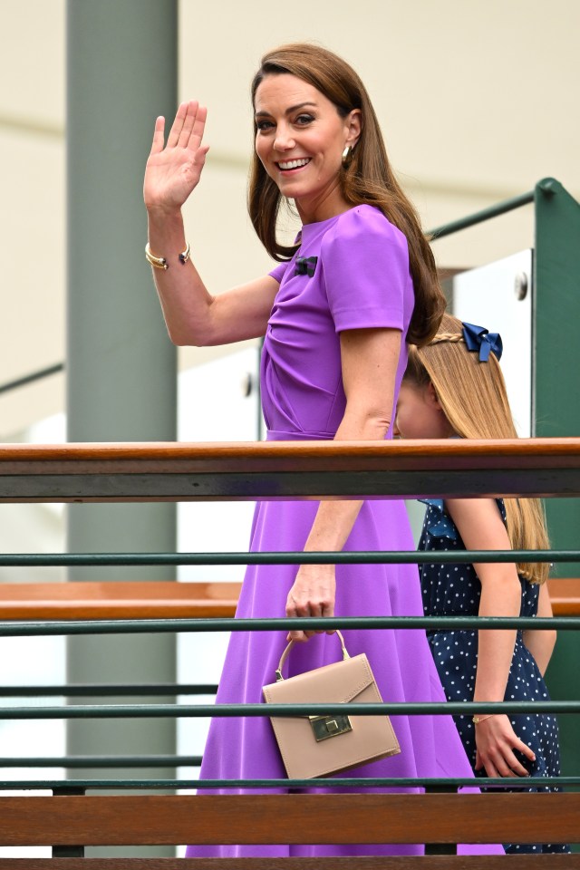 a woman in a purple dress holds a pink purse