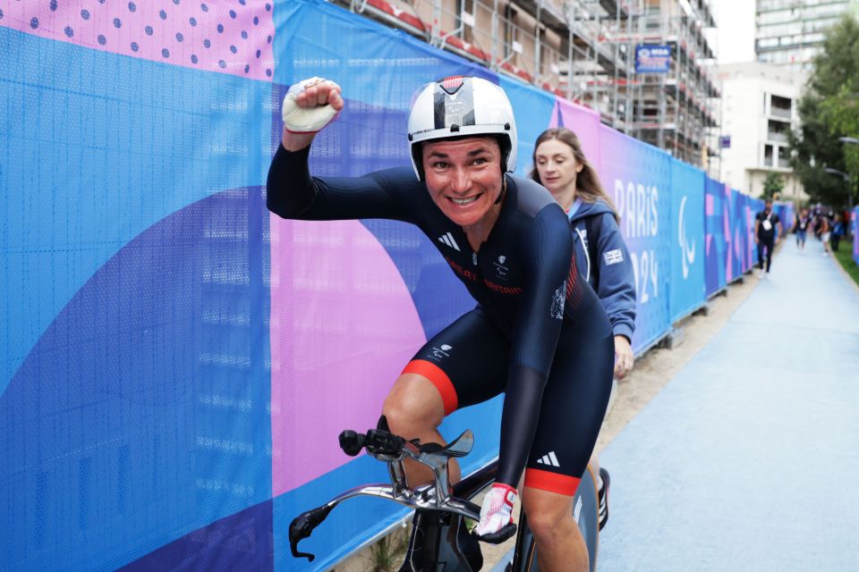 Sarah Storey celebrates winning gold in the road cycling time trial event in Paris