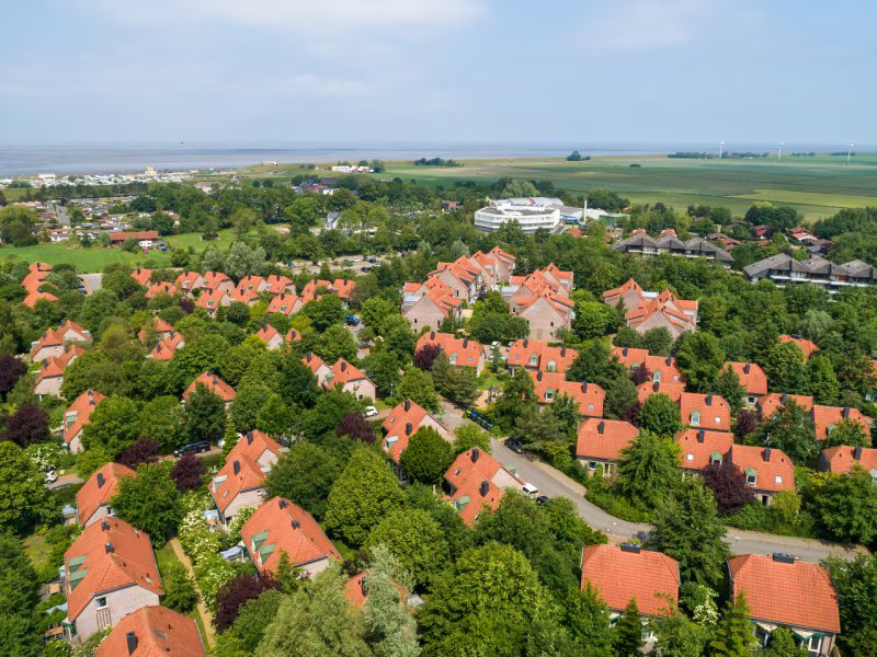 an aerial view of a residential area with red roofs