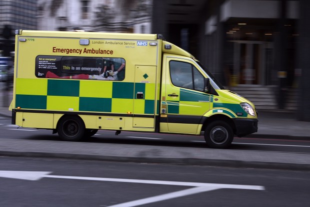 an ambulance from the london ambulance service is driving down the street