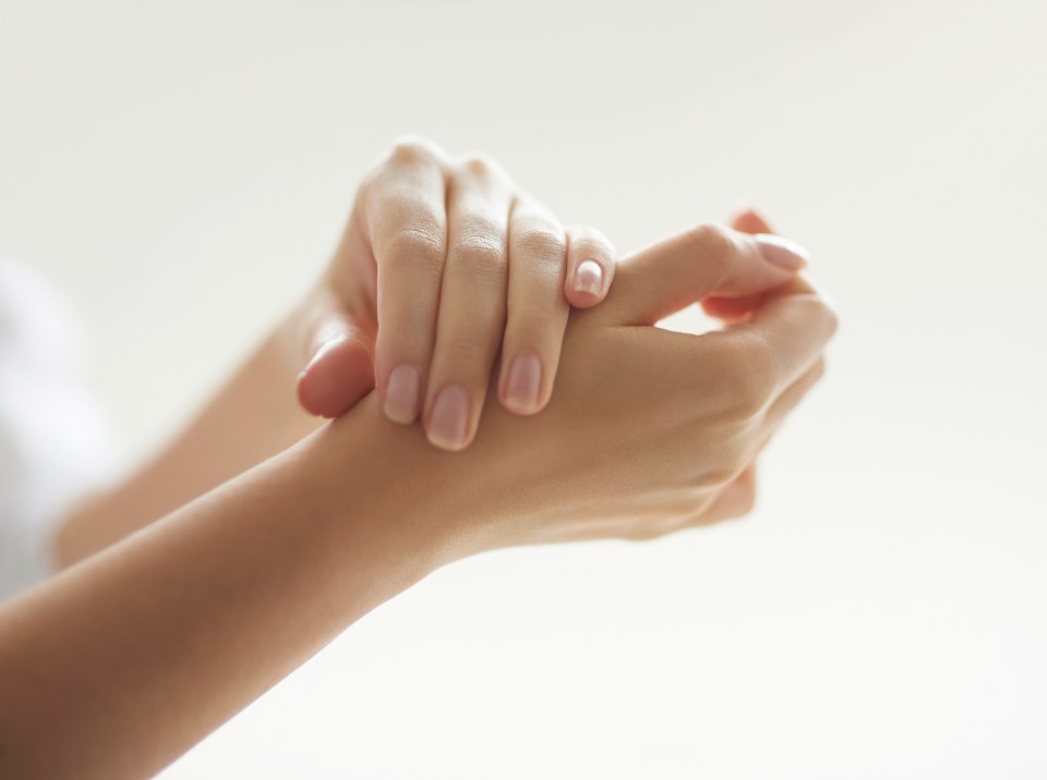 a close up of a woman 's hands on a white background