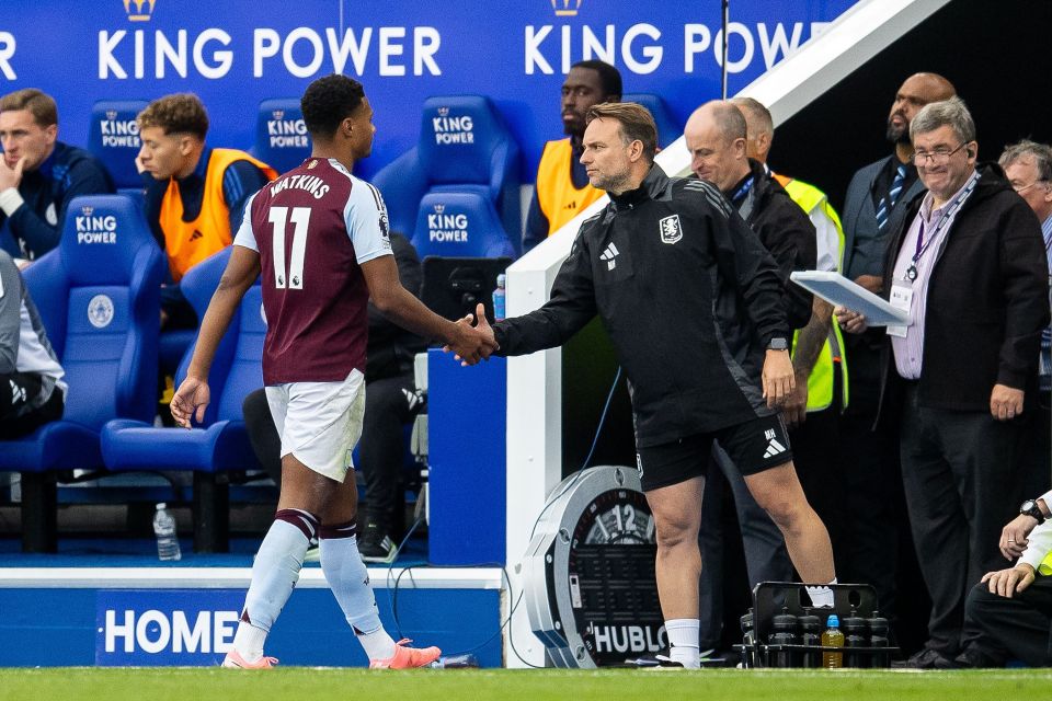 a soccer player wearing number 11 shakes hands with another player