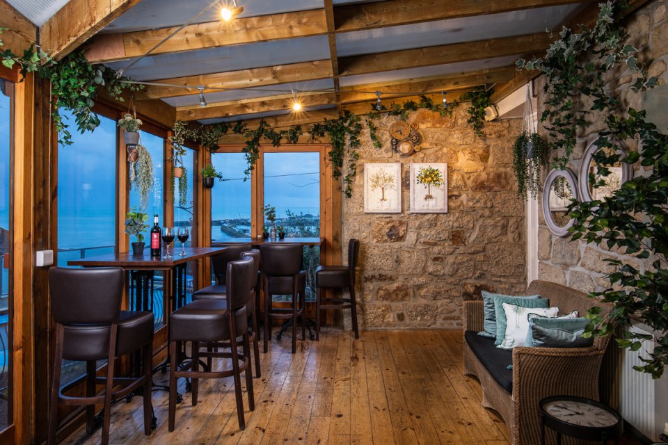 a room with tables and chairs and a clock