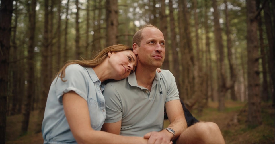 a man and a woman are sitting in the woods