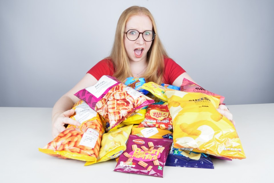 a woman is holding a bag of peanut nuggets