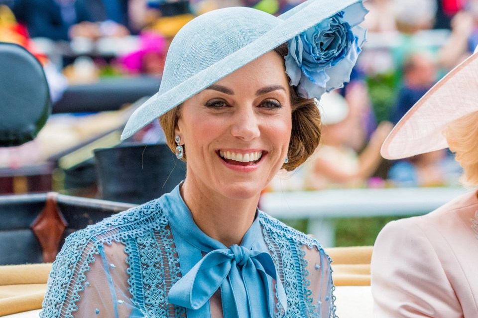 a woman wearing a blue hat and a blue dress smiles