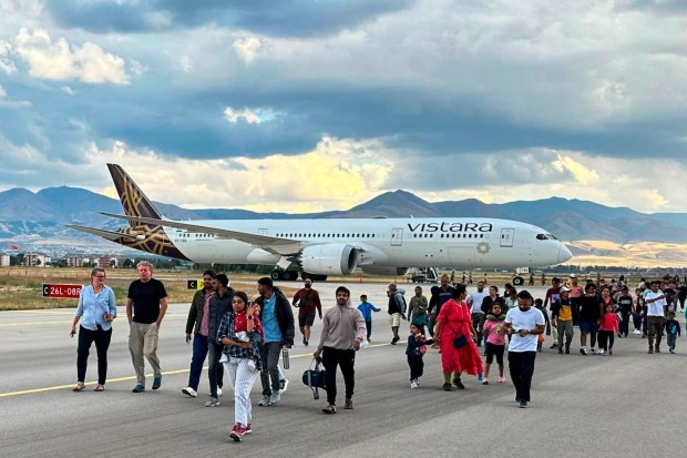 a vistara airlines plane is parked on the runway