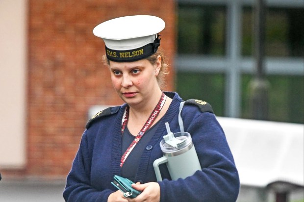 a woman in a navy uniform has the name nelson on her hat