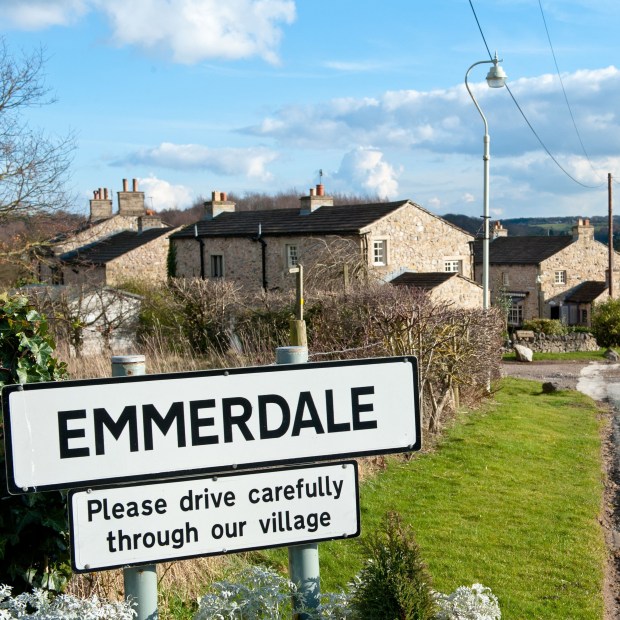 a sign that says &quot; please drive carefully through our village &quot;