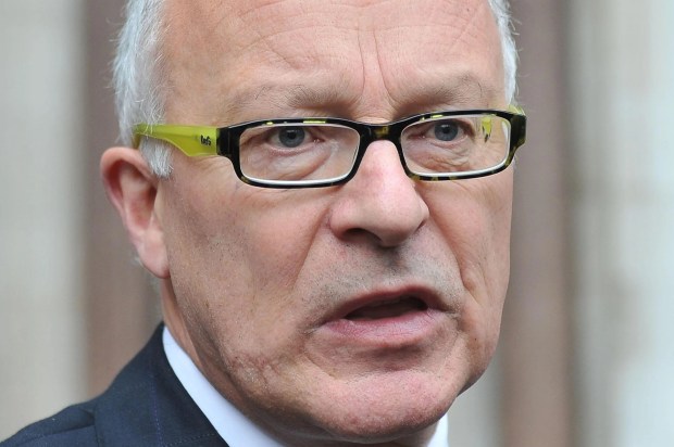 a man wearing glasses and a green tie