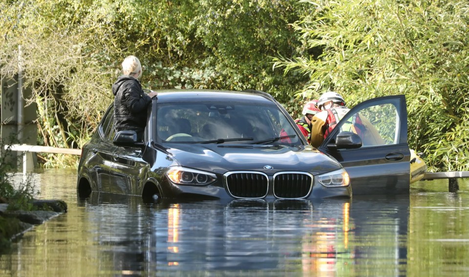 Two women were rescued after their car became stuck in 3ft of water in Essex on Thursday