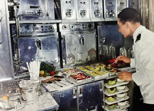 a man prepares food in a galley on a cruise ship