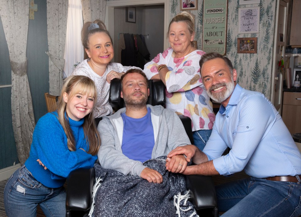 a group of people standing around a man in a wheelchair