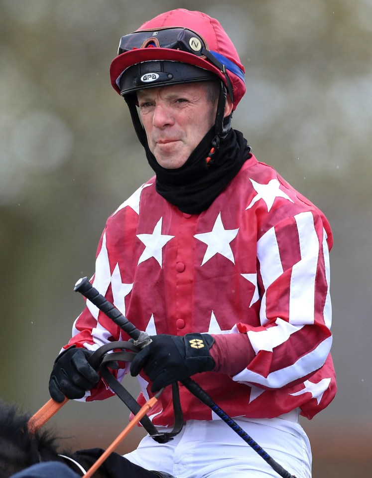 a jockey wearing a helmet with the word bell on it