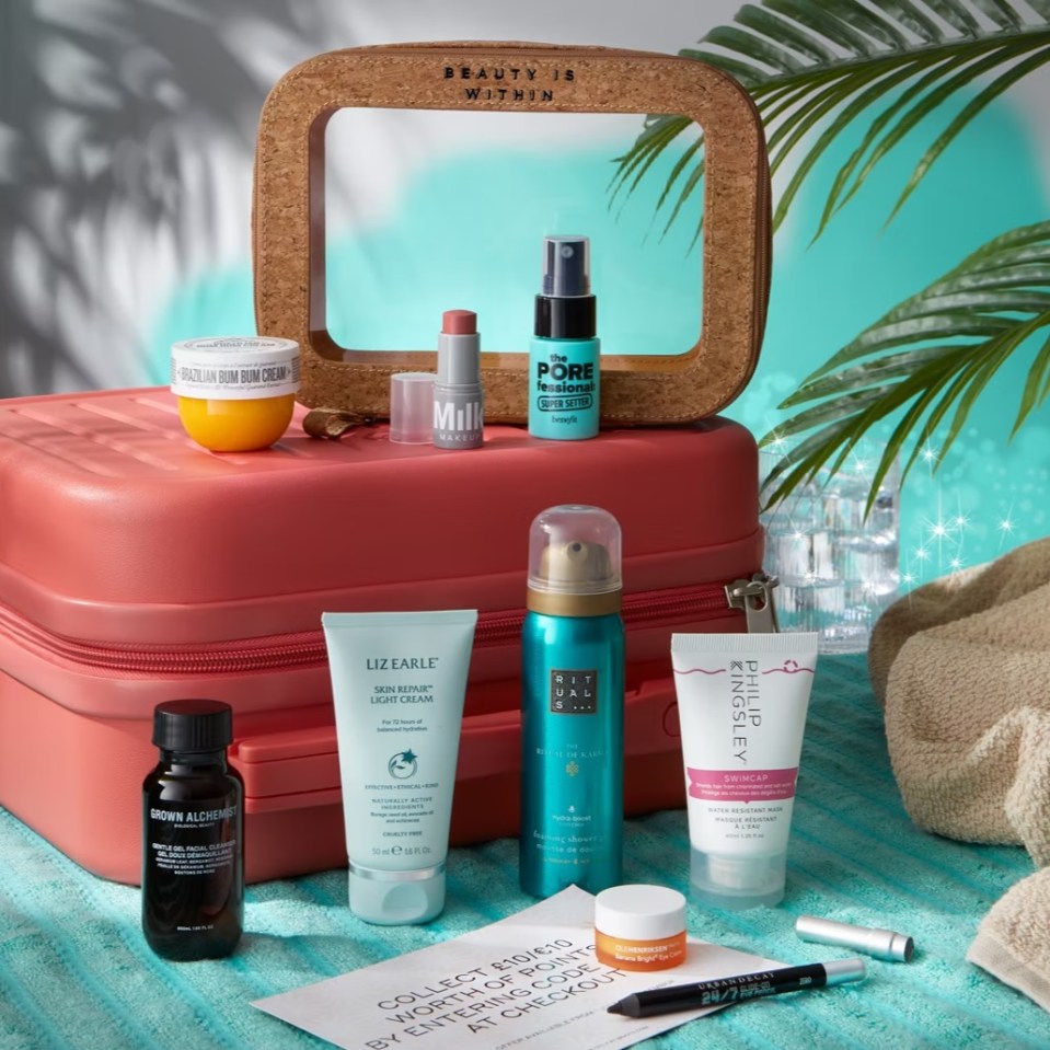 a pink suitcase filled with beauty products including liz earle