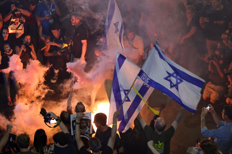 a group of people holding flags with a star of david on them