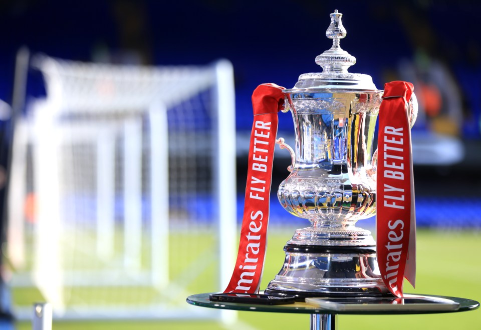 a trophy with emirates fly better ribbons around it