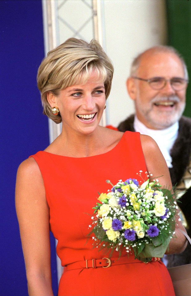 a woman in a red dress is holding a bouquet of flowers