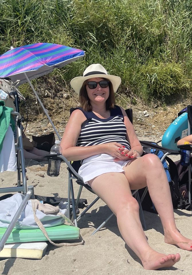 Caroline on a beach in Cornwall this summer a year after suffering a spinal stroke