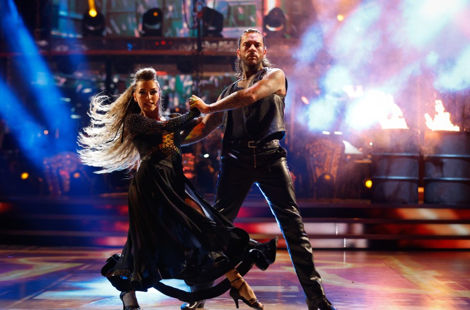 a man and a woman are dancing on a stage