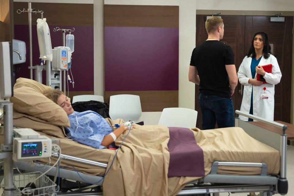 a woman is laying in a hospital bed while a man and a doctor look on