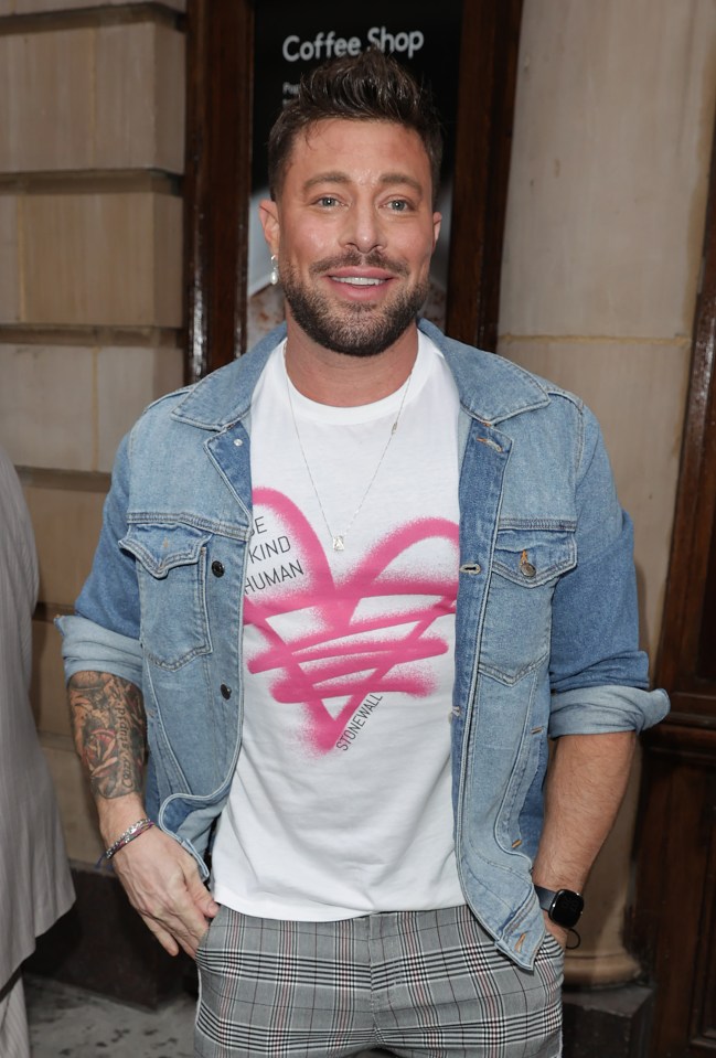 a man wearing a white shirt that says be kind human