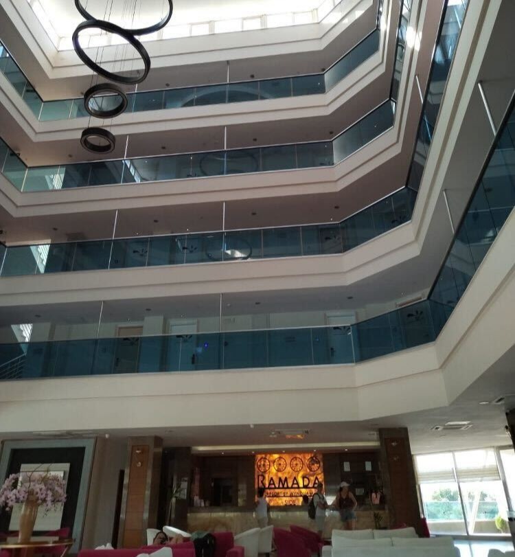 a large hotel lobby with a ramada sign on the wall