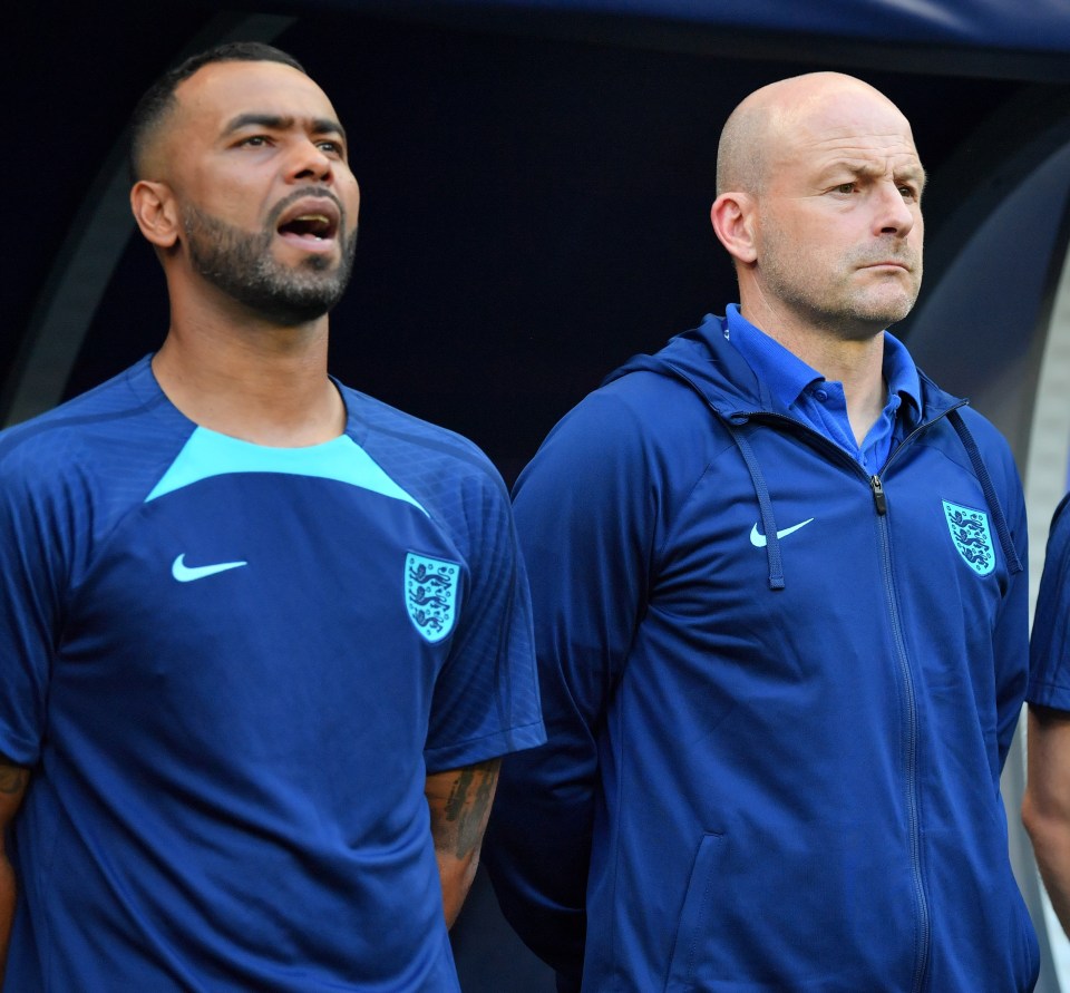 a man in a blue nike shirt stands next to another man