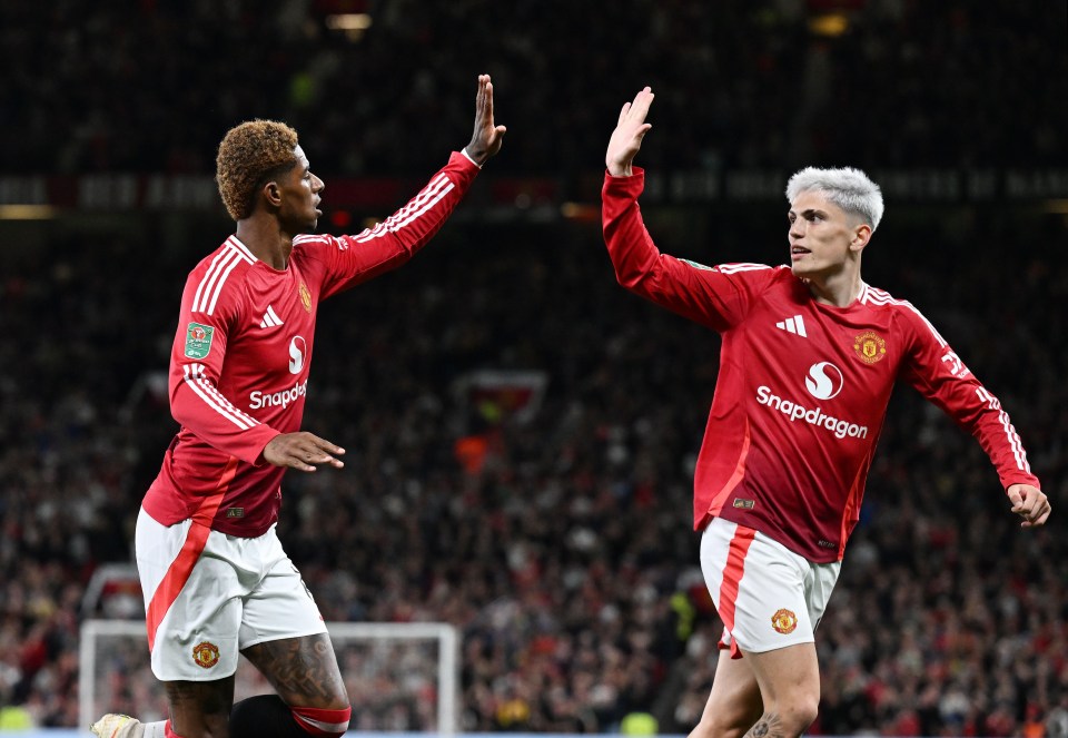 two soccer players wearing snapdragon jerseys high five each other