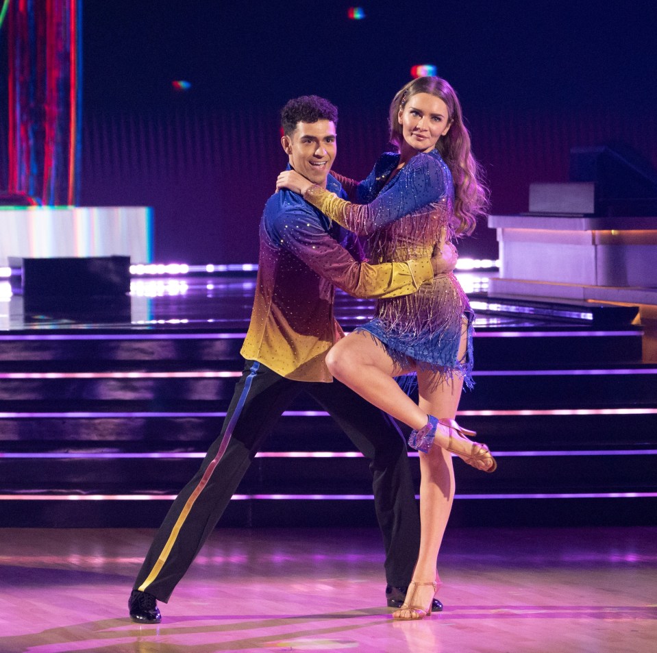 a man and a woman are dancing on a dance floor