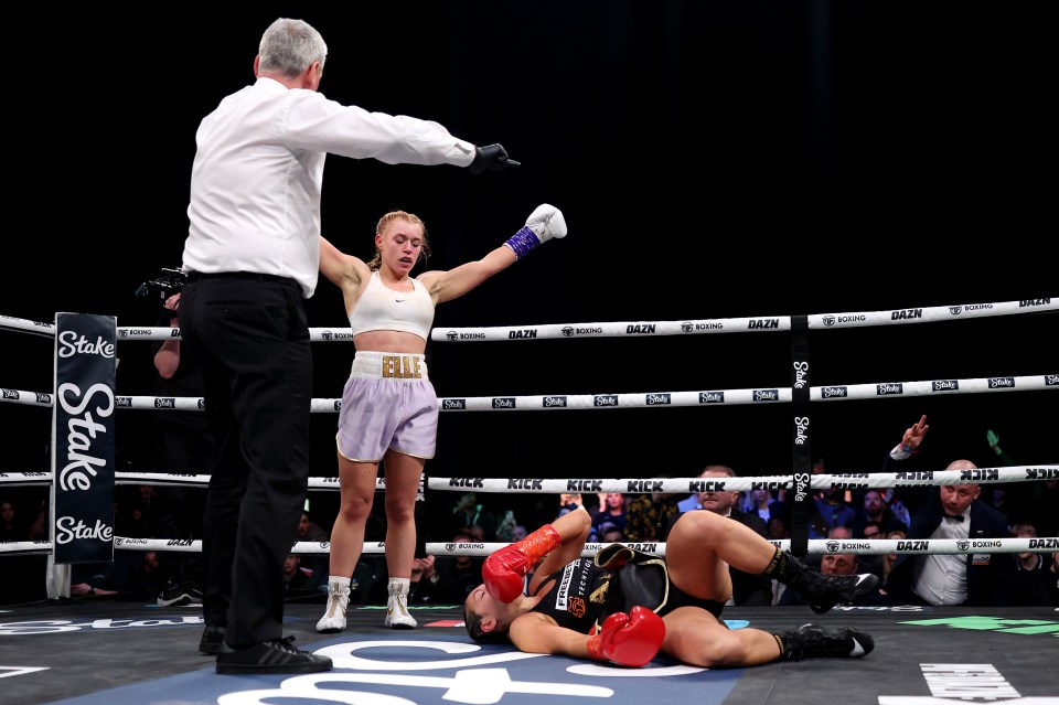 a woman in a boxing ring with the word elle on her shorts