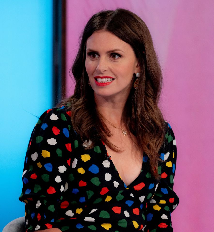 a woman wearing a colorful polka dot dress is smiling