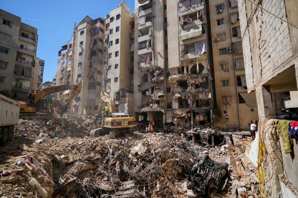 a cat excavator is being used to demolish a building