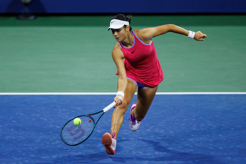 a woman playing tennis with a wilson racquet