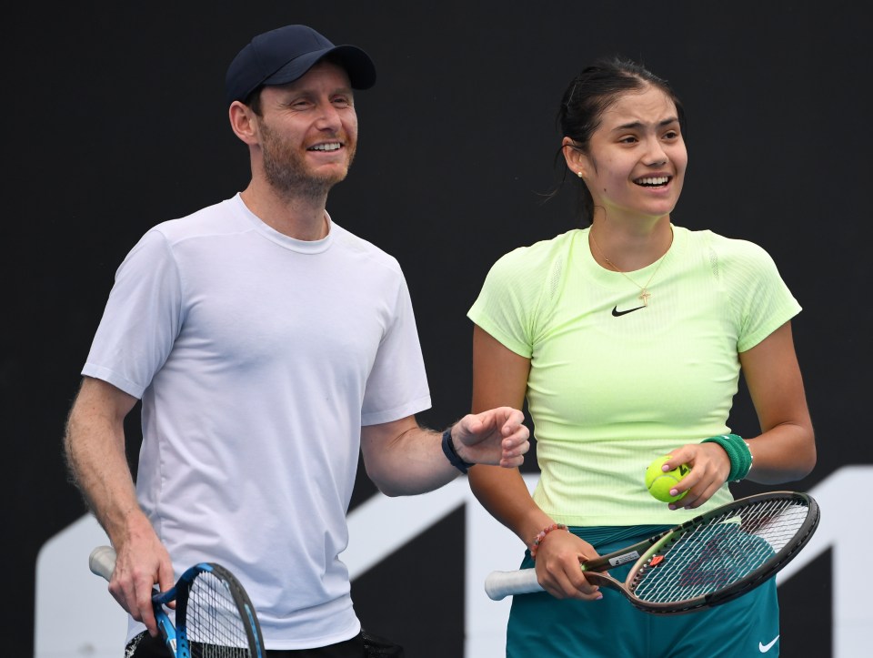 a man and a woman are holding tennis rackets and smiling