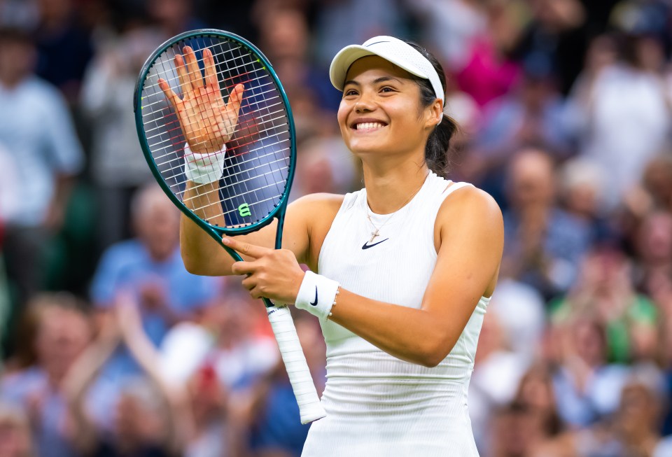 a woman holding a tennis racquet with the letter e on it