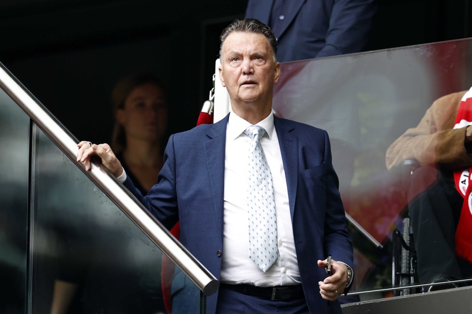 a man in a suit and tie stands in a stadium