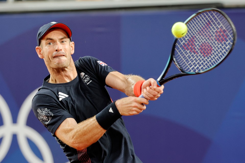 a man playing tennis with a british flag on his shirt