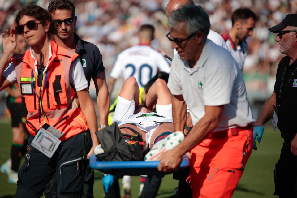 a soccer player with the number 20 on his jersey is being stretchered off the field