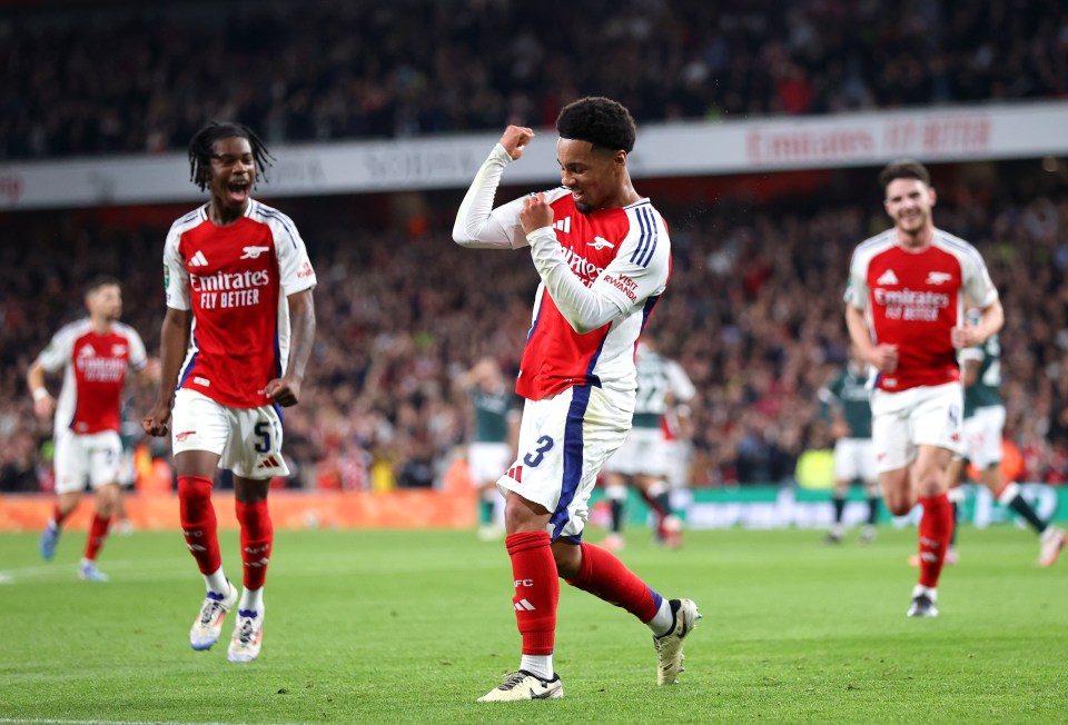 a soccer player wearing a jersey that says emirates fly better